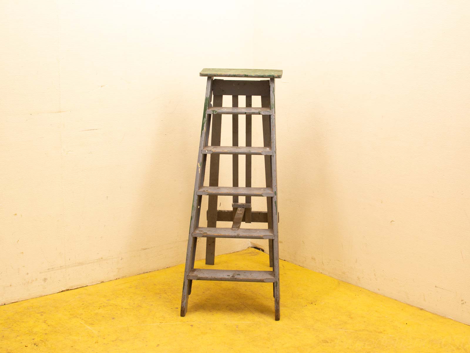 Vintage wooden step ladder with five rungs, showcasing weathered charm and practical design.