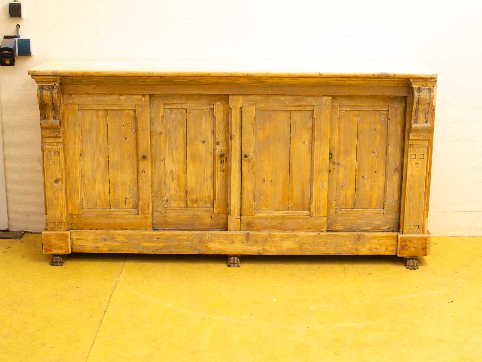 Rustic Wooden Cabinet with Unique Animal Paw Details and Natural Finish