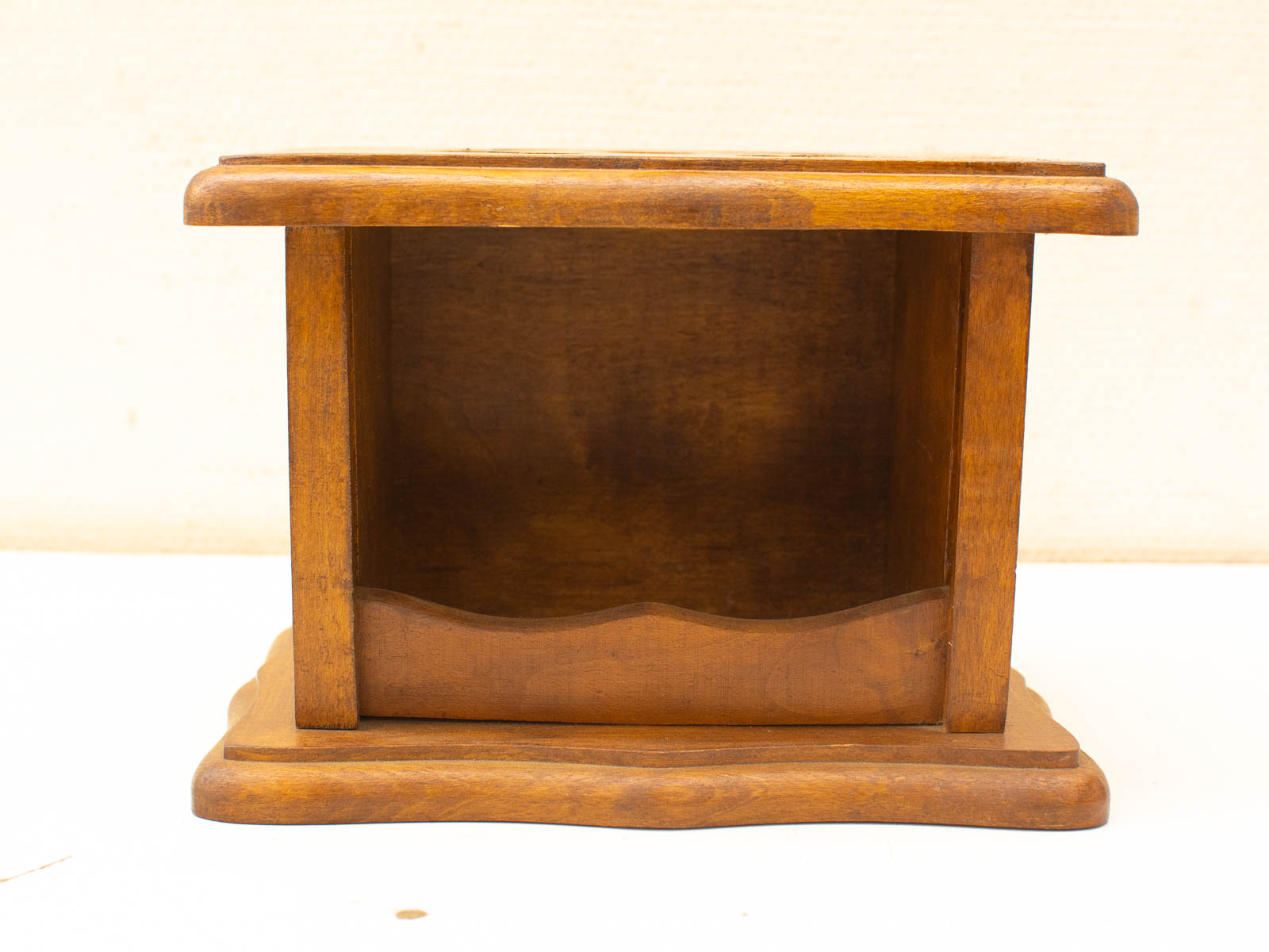 Elegant wooden box with scalloped edge, perfect for storage or decorative use in cozy spaces.