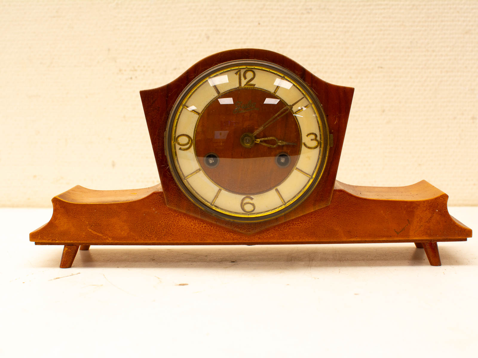 Vintage mahogany mantel clock with classic design and warm finish, perfect nostalgic home decor.