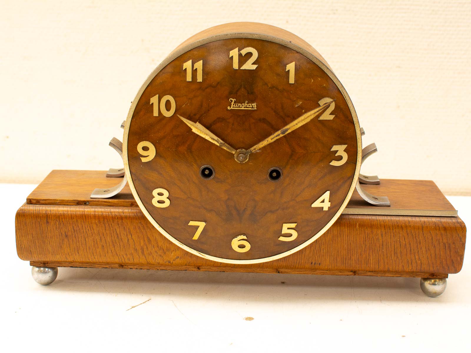 Elegant vintage wooden mantel clock with gold hands and bold numbers for classic decor.