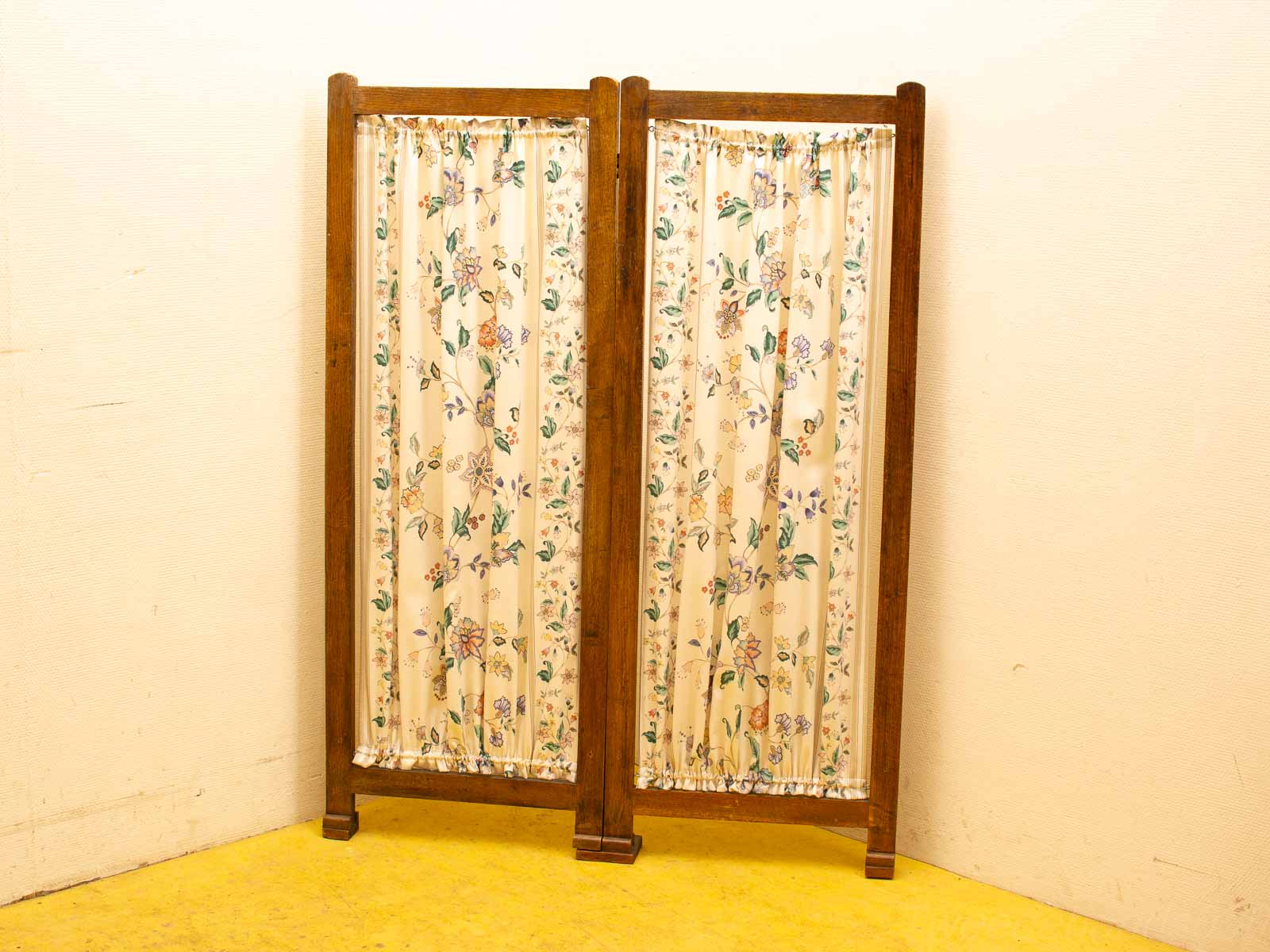 Vintage room divider with floral curtains, perfect for stylishly separating spaces.