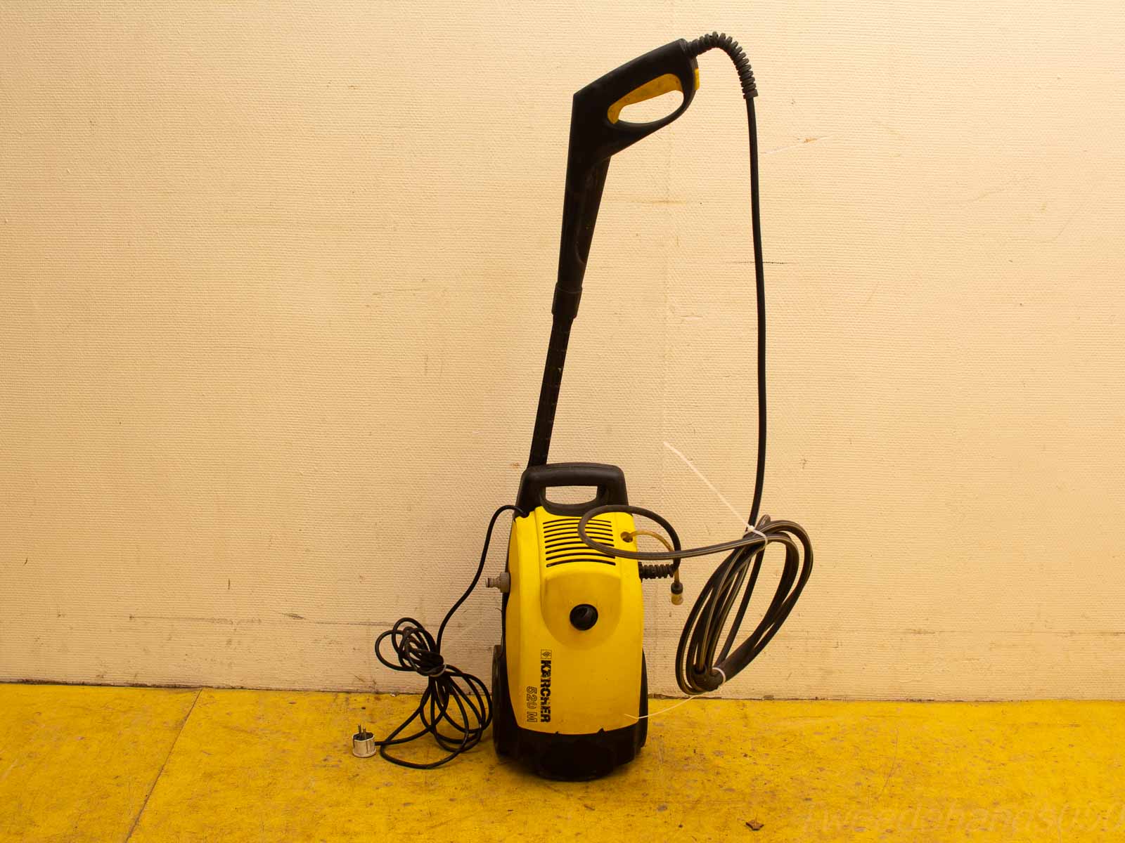 Powerful yellow and black pressure washer, designed for effective cleaning with ergonomic features.