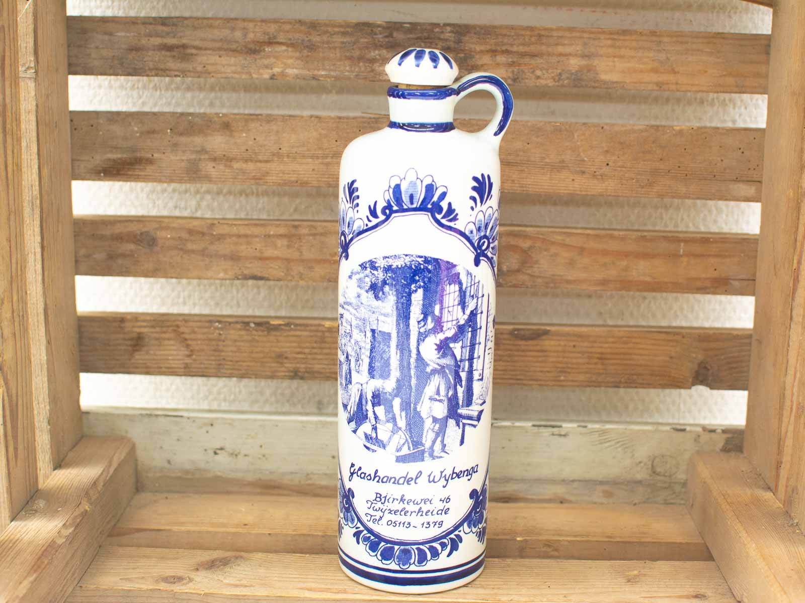 Vintage ceramic bottle featuring historical scene and floral patterns, symbolizing cultural heritage.