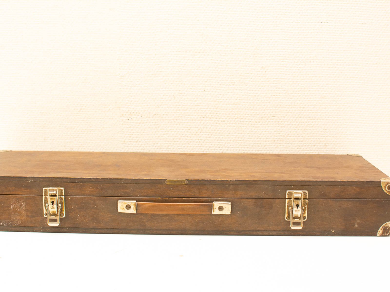 Vintage wooden case with sturdy handle and metal latches on a white background.