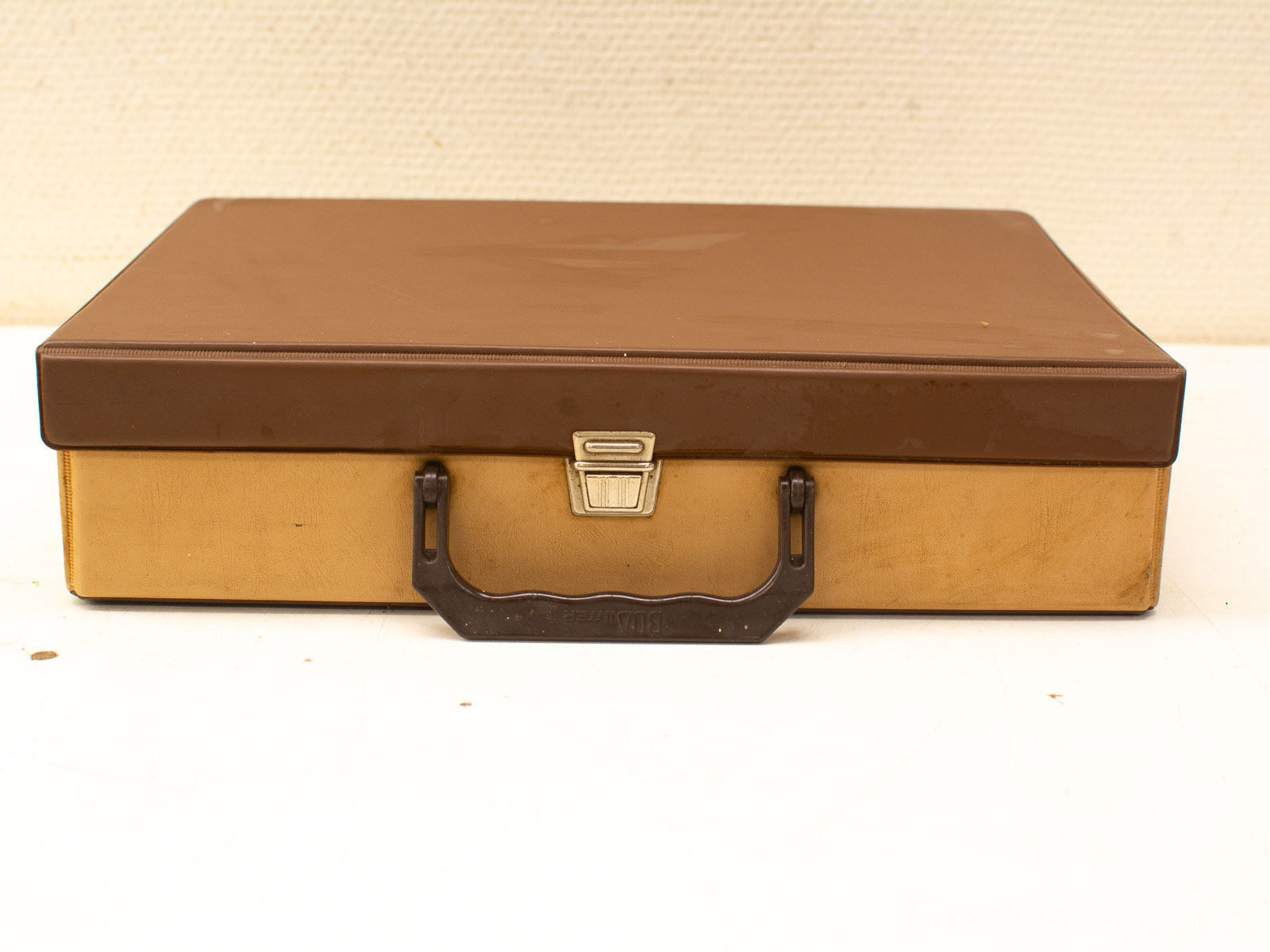 Stylish vintage storage box with metallic latch, glossy brown top and durable design.