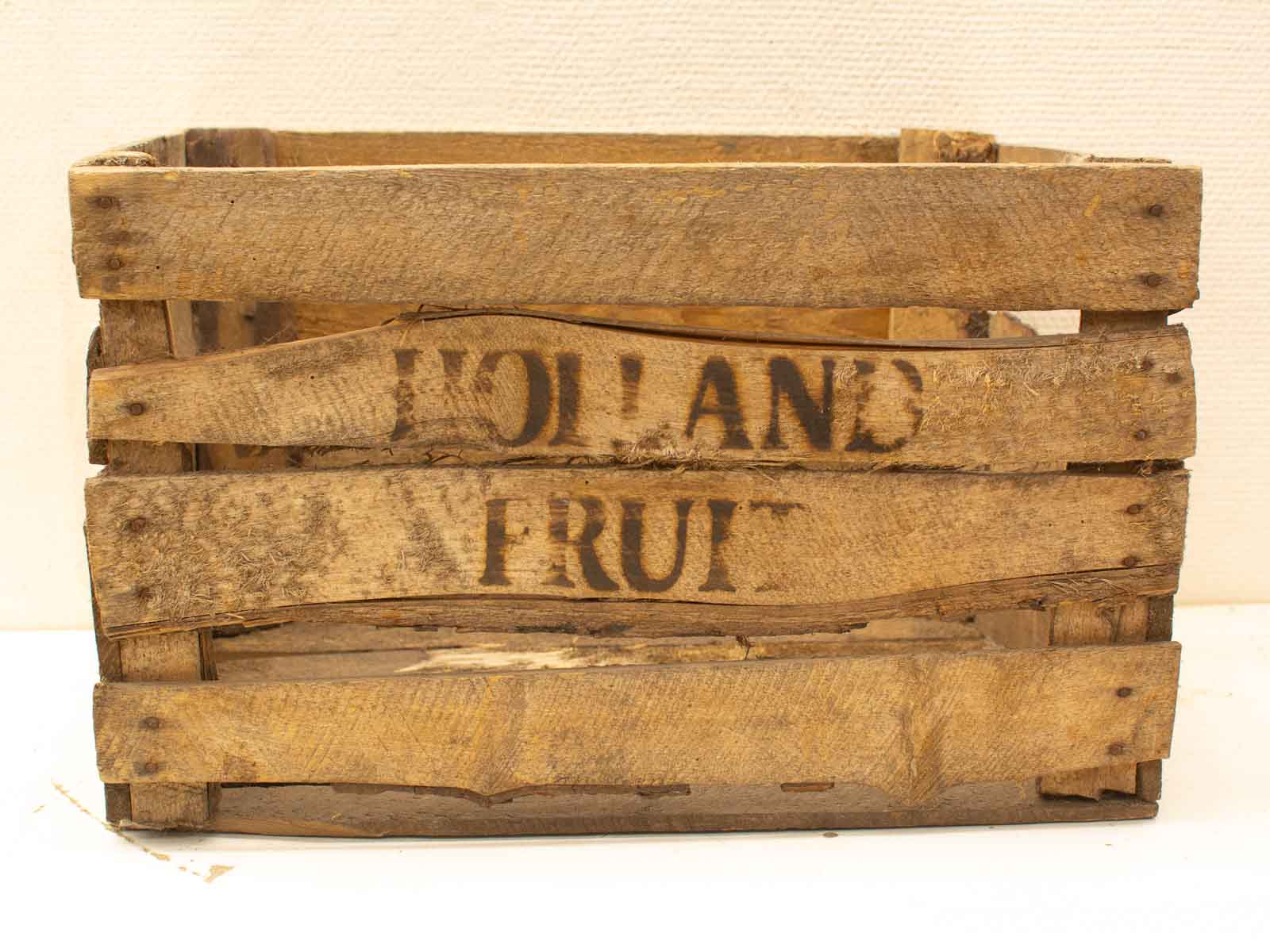 Vintage wooden Holland Fruit crate, rustic decor with signs of wear and hand-painted text.