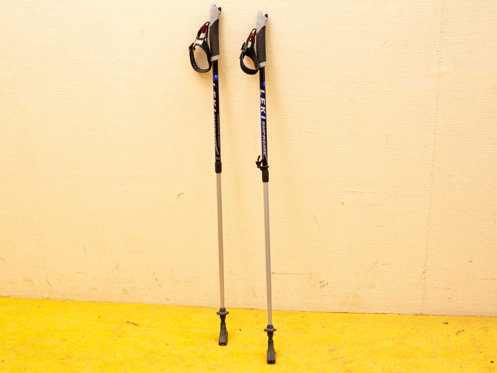 Adjustable gray trekking poles with blue accents, providing comfort and stability for outdoor adventures.