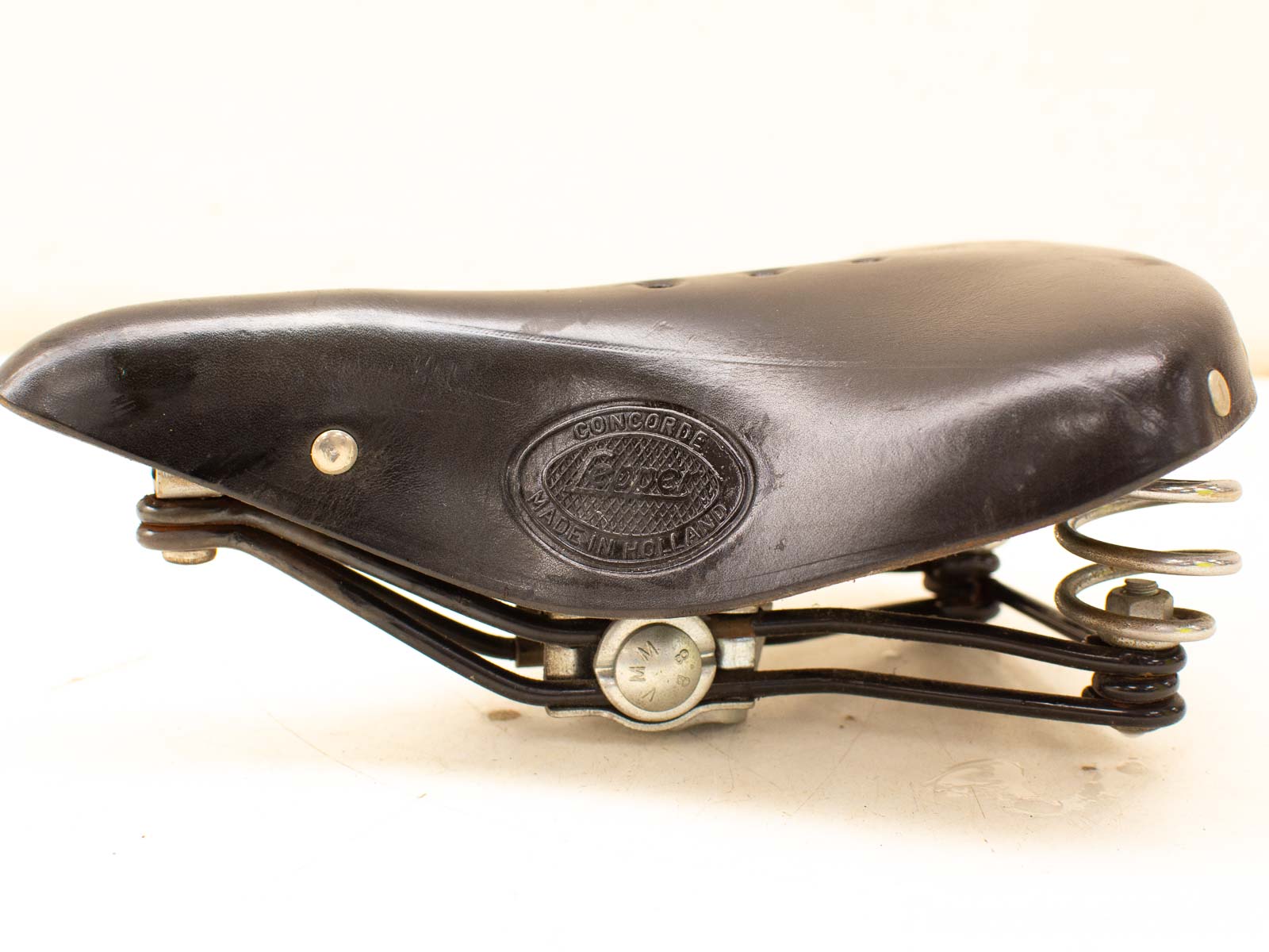 Classic vintage Concor bicycle saddle from the Netherlands, featuring durable design and comfort-focused springs.