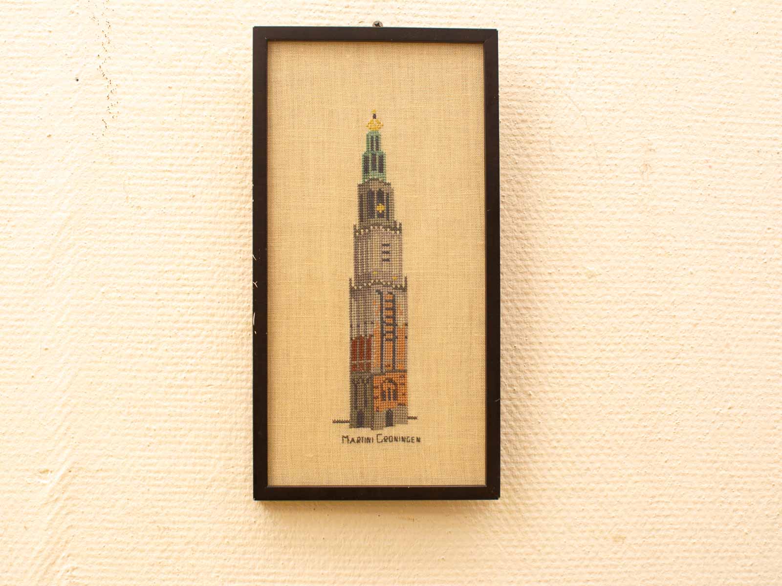 Elegant cross-stitch art of Groningens Martini Tower, showcasing its historical beauty and craftsmanship.