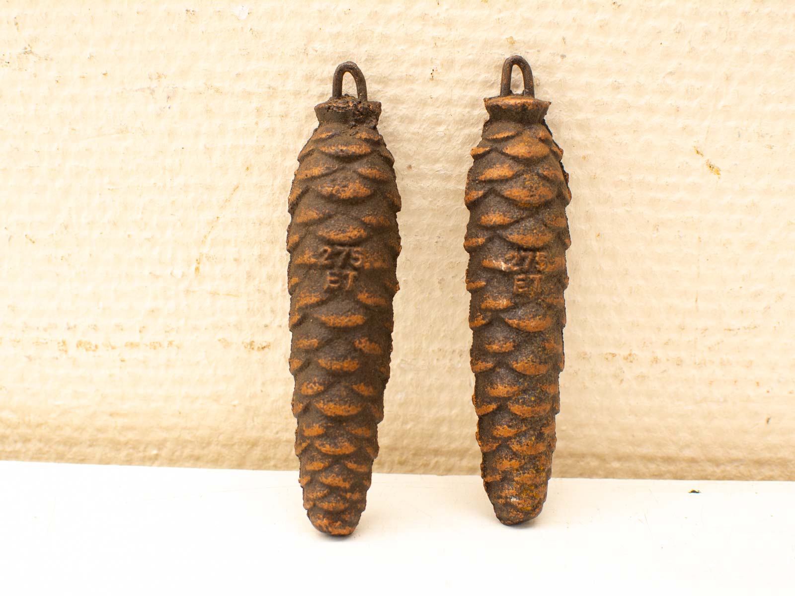 Rusty iron pine cone sculptures add vintage charm and unique character to any decor.