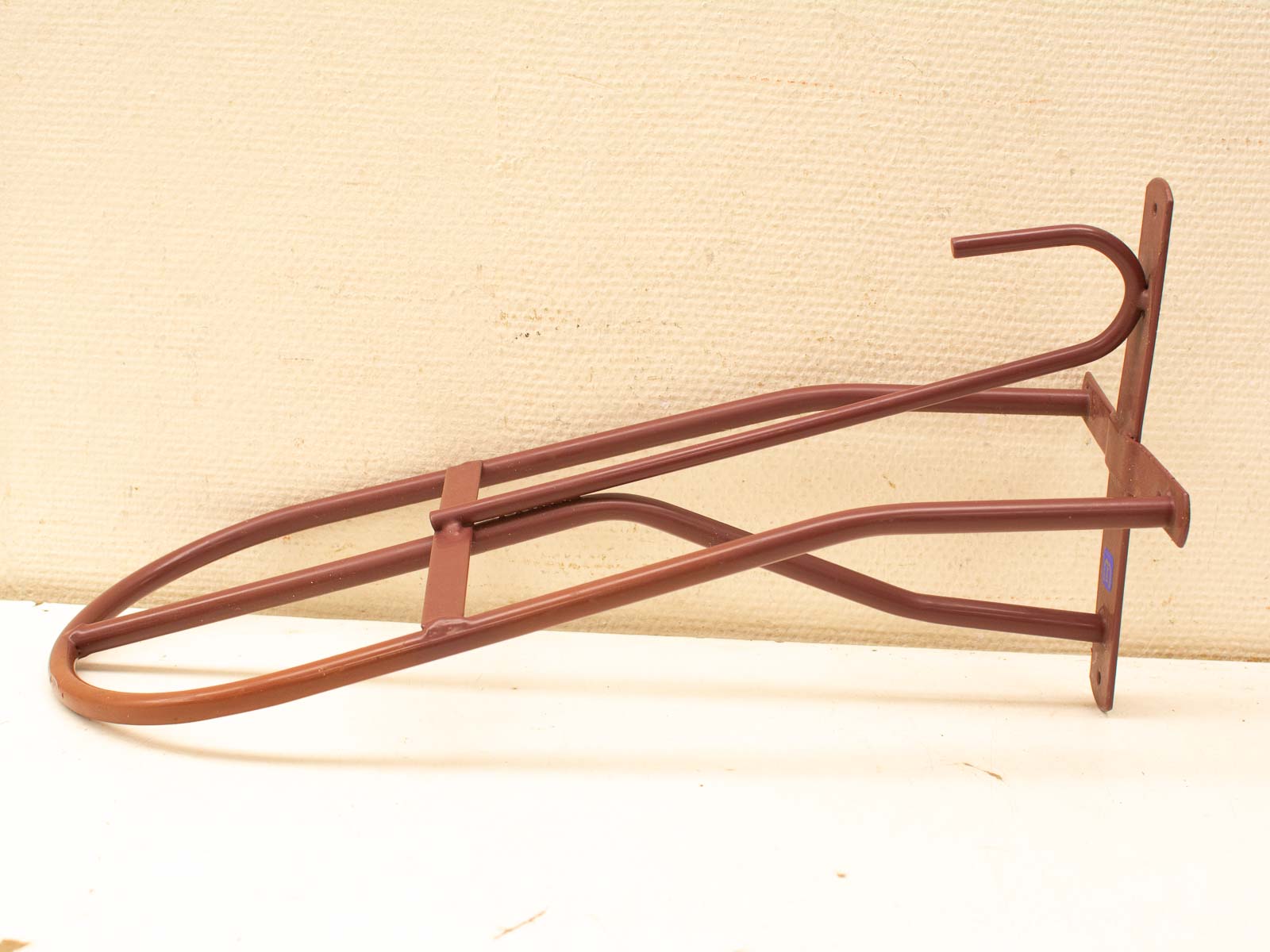 Stylish brown metal bike rack for wall mounting, perfect for home and commercial use.