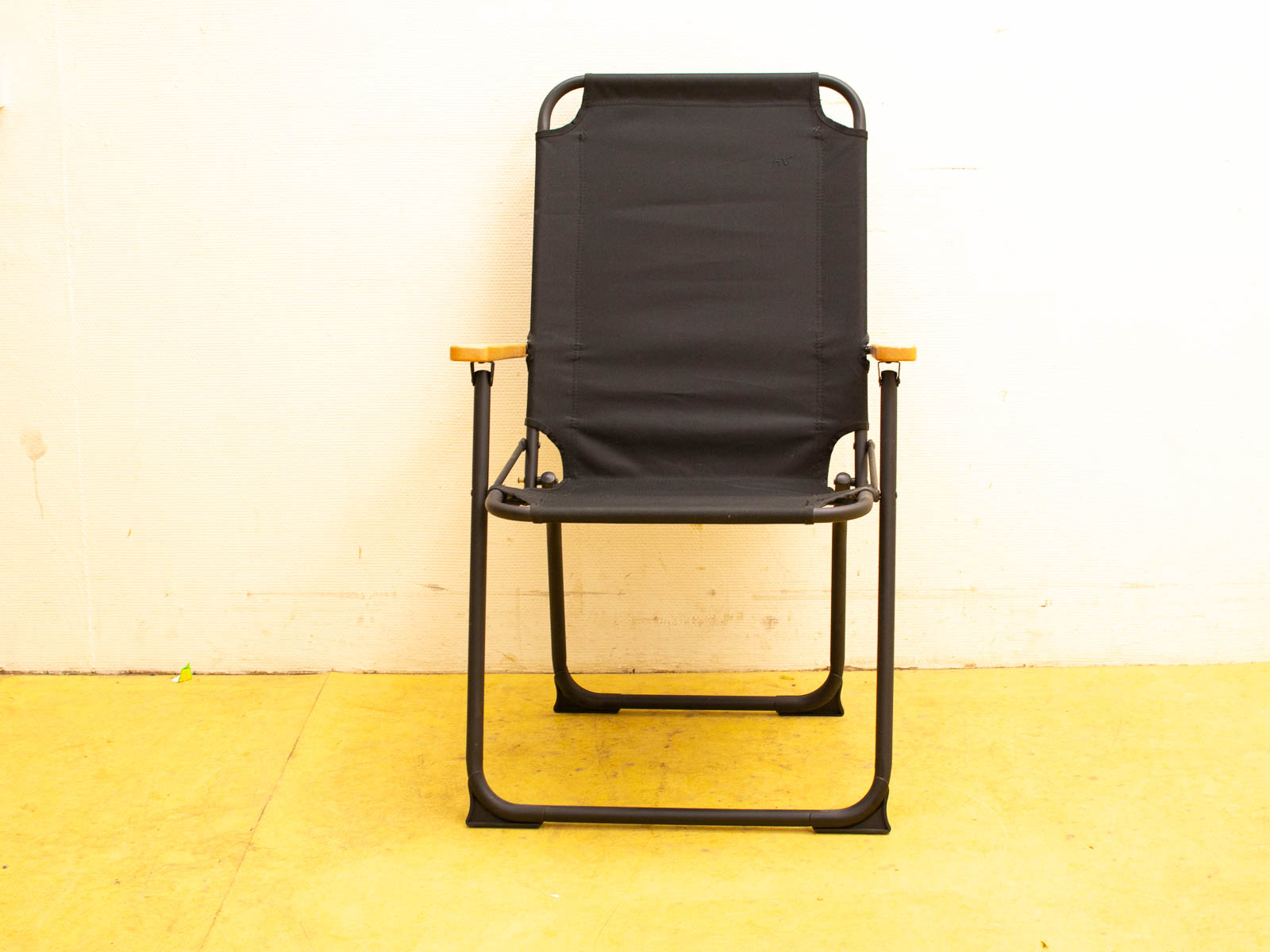 Stylish minimalist chair with black metal frame and warm wooden armrests, perfect for any space.