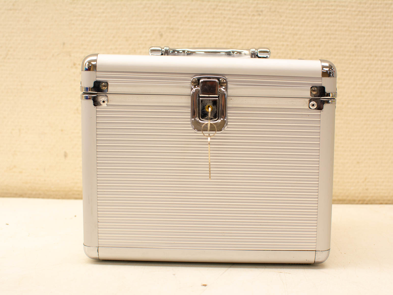 Sleek metallic storage case in white and silver, perfect for securing vintage items.