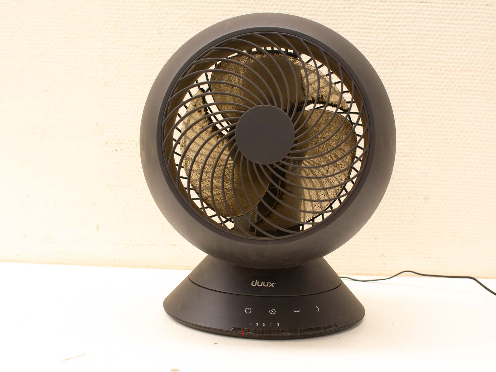 Sleek black minimalist fan for home cooling, featuring adjustable airflow and user-friendly controls.