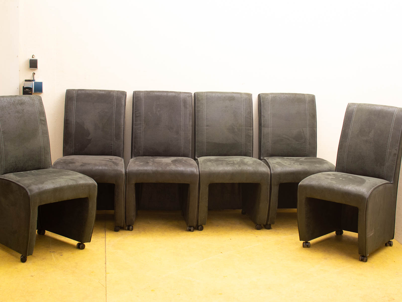 Modern gray chairs in a semi-circle, ideal for versatile meeting and gathering spaces.