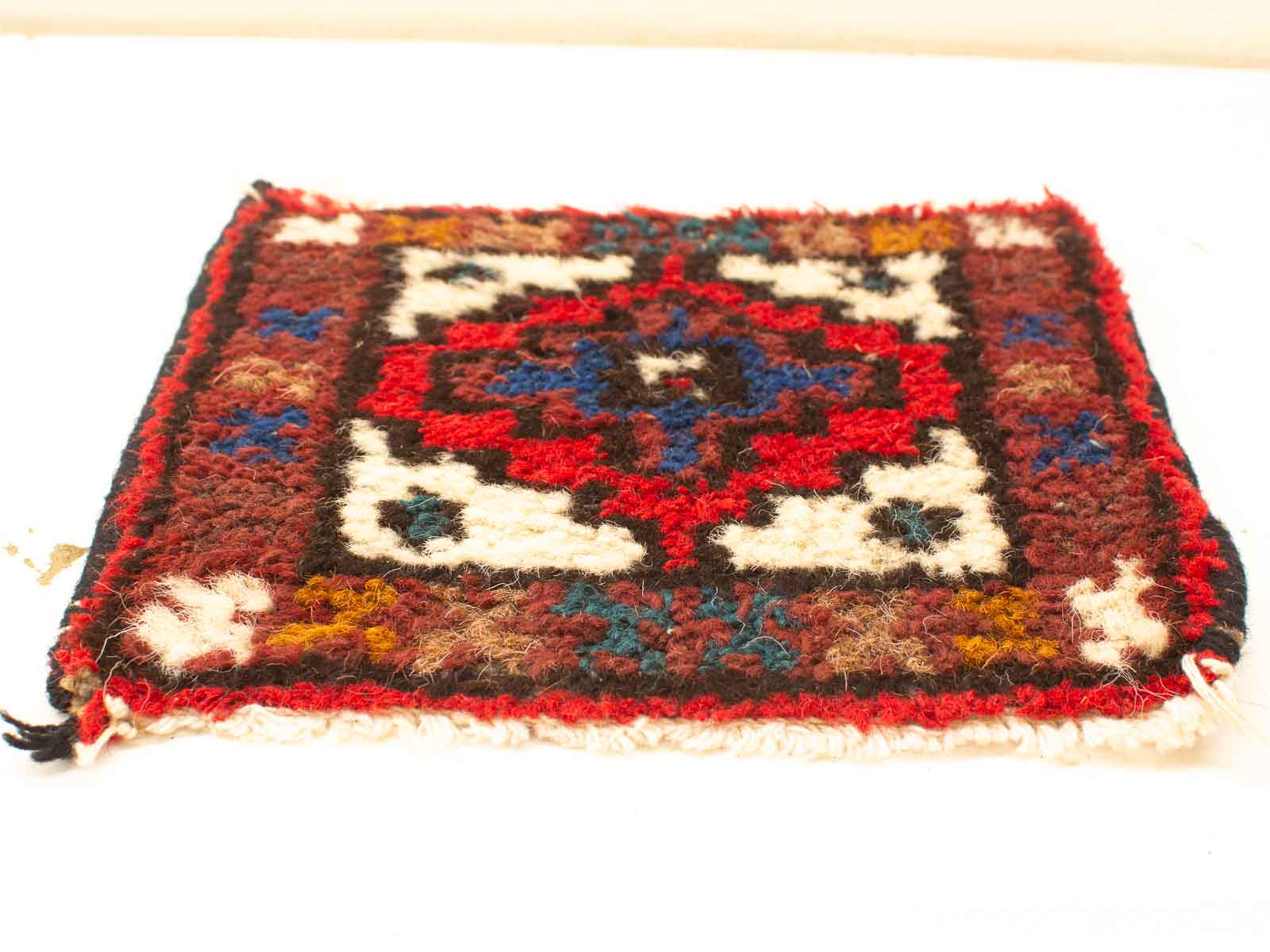 Vibrant vintage wool rug with red diamond motif and intricate geometric patterns for stylish decor.