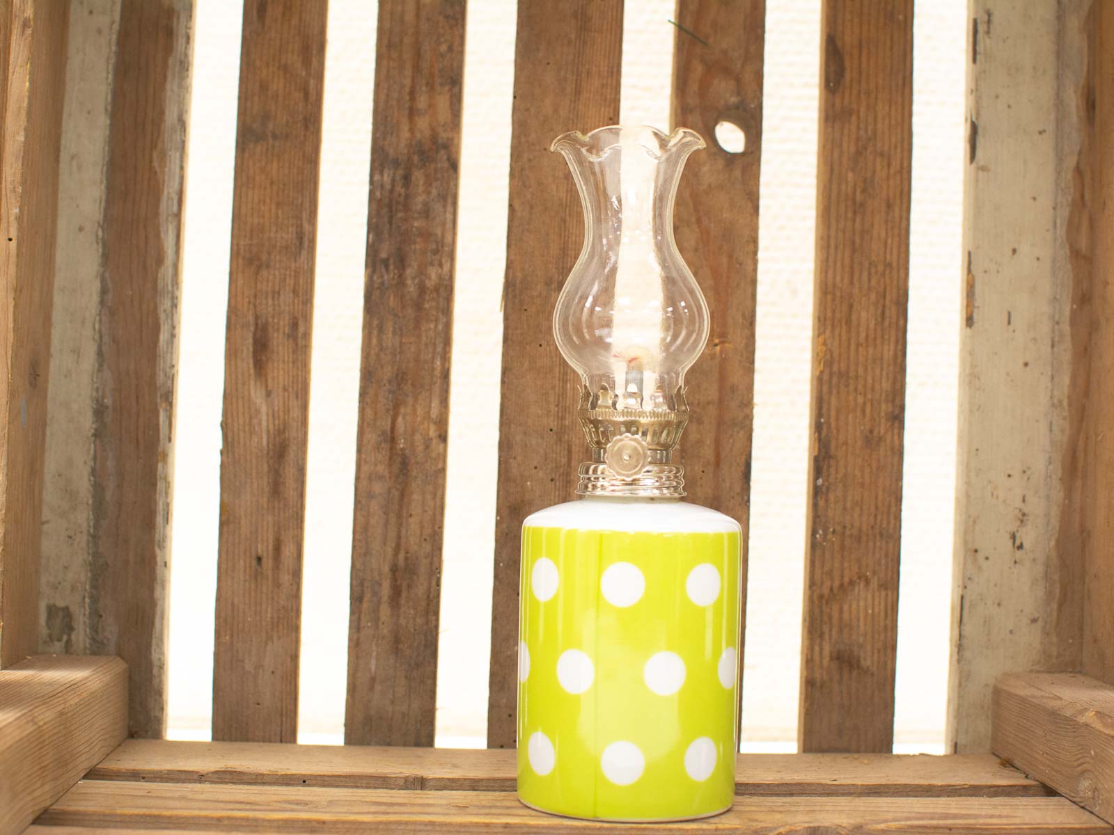 Whimsical vintage oil lamp with flower chimney and vibrant polka dot base for charming decor.