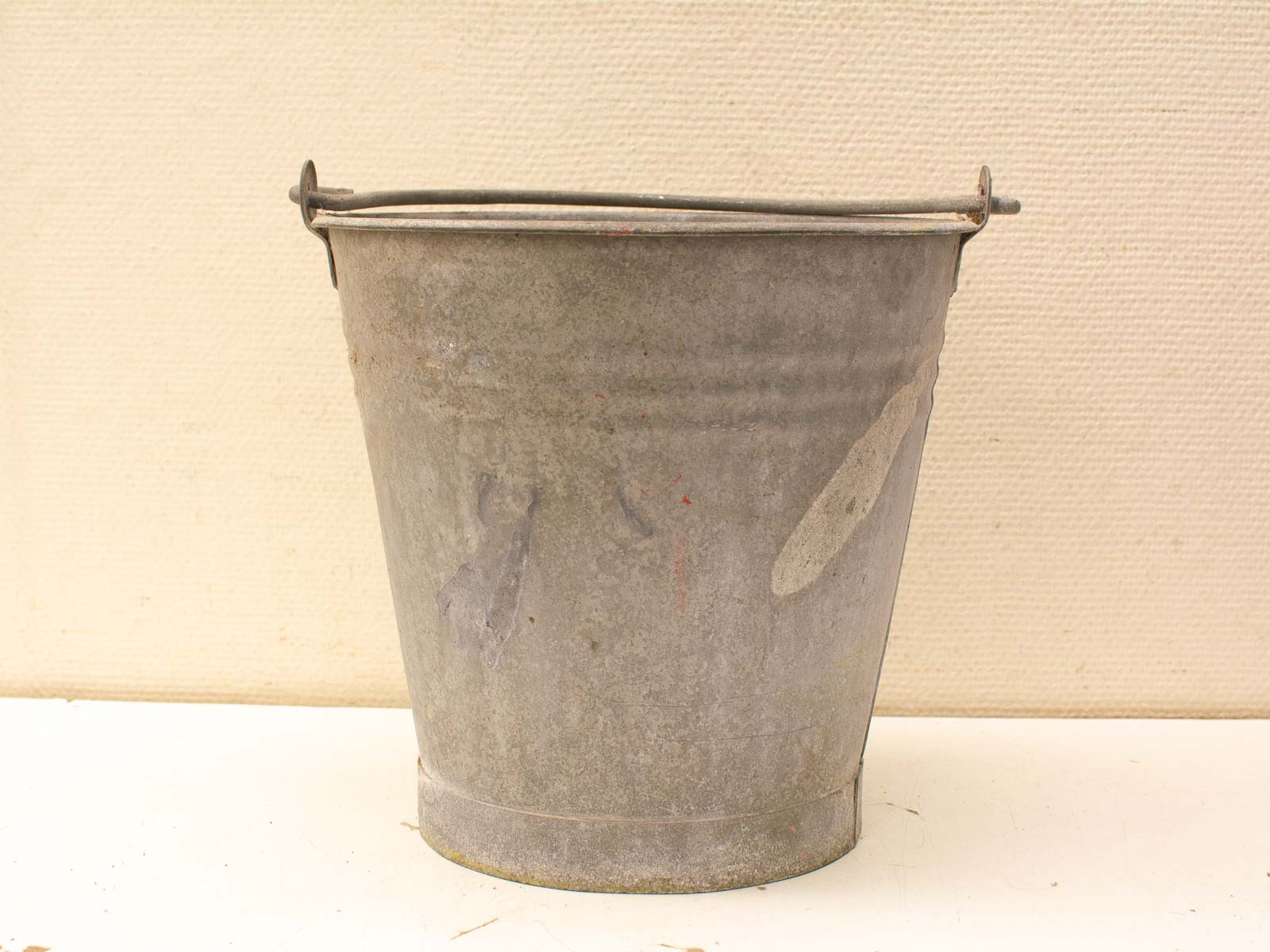 Rustic vintage metal bucket for charming home decor and gardening use.