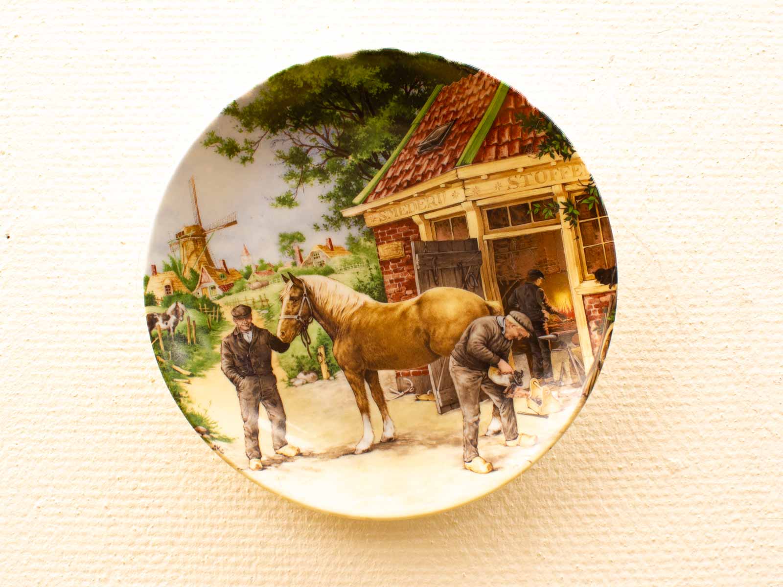 Rustic Decorative Plate Featuring Horse, Blacksmith, and Countryside Landscape