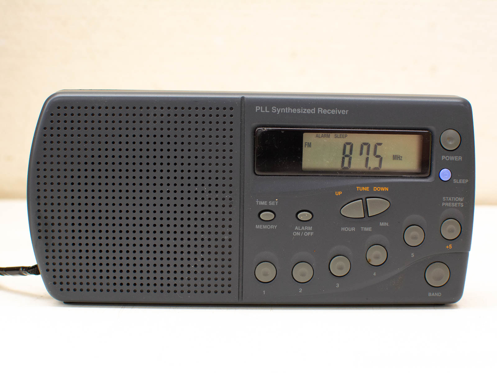 Sleek PLL radio receiver with alarm function, digital display, and intuitive controls for easy use.