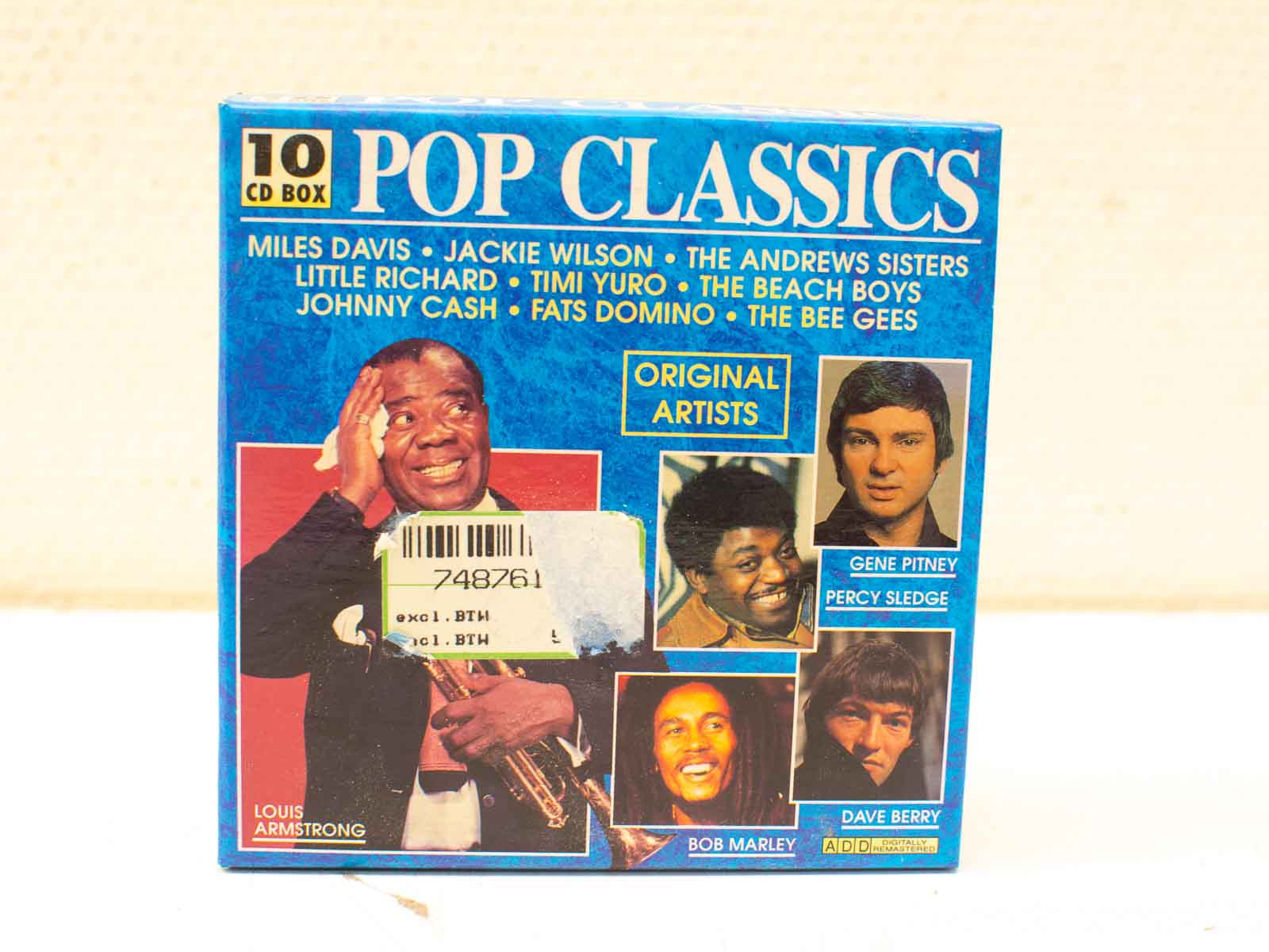 Vibrant Pop Classics CD set with Louis Armstrong and iconic artists celebrating timeless pop music.