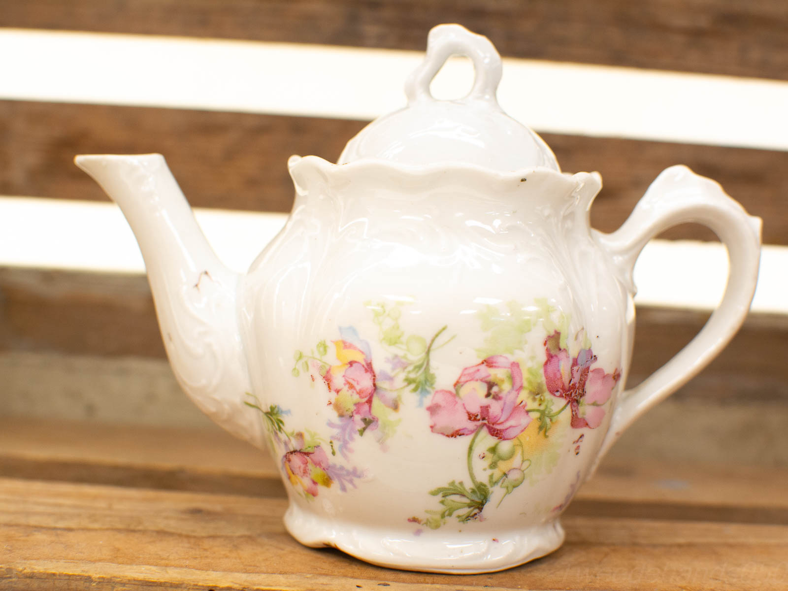 Elegant antique porcelain teapot with floral designs, perfect for tea lovers and vintage collections.