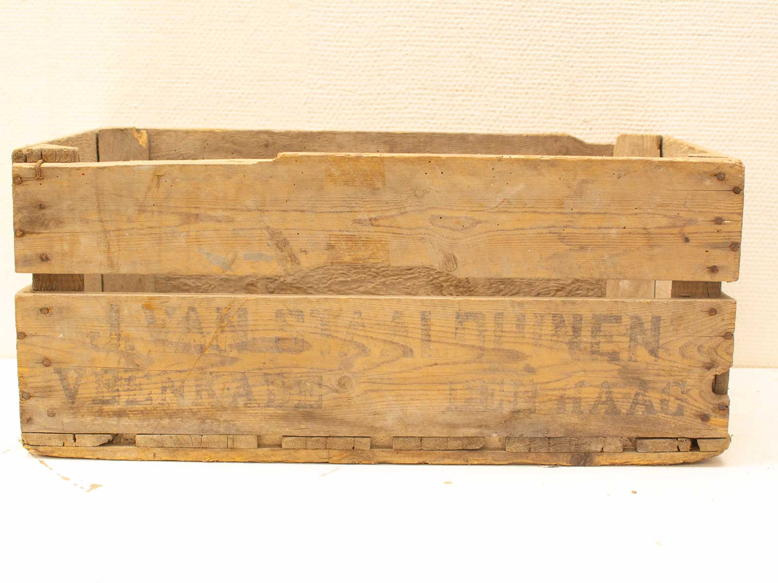 Rustic wooden crate with vintage inscriptions, showcasing durable craftsmanship and nostalgic charm.