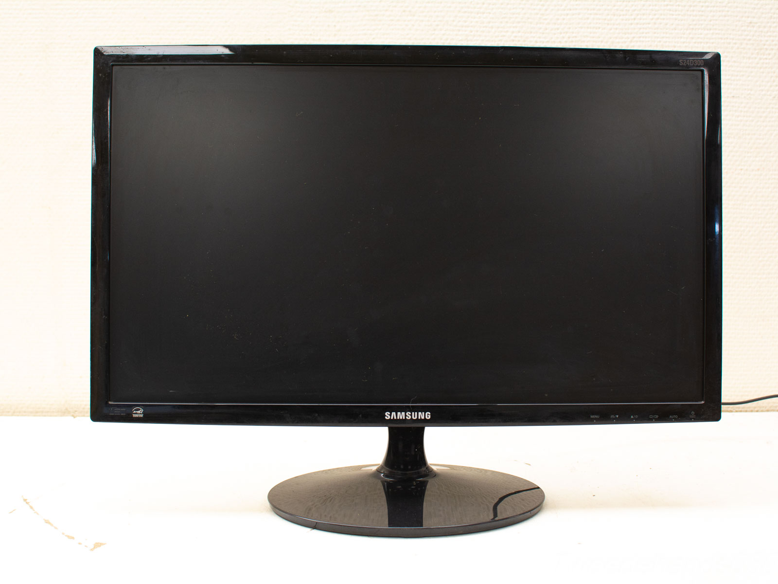 Stylish black Samsung monitor with glossy finish, minimalist design, and circular stand for any workspace.