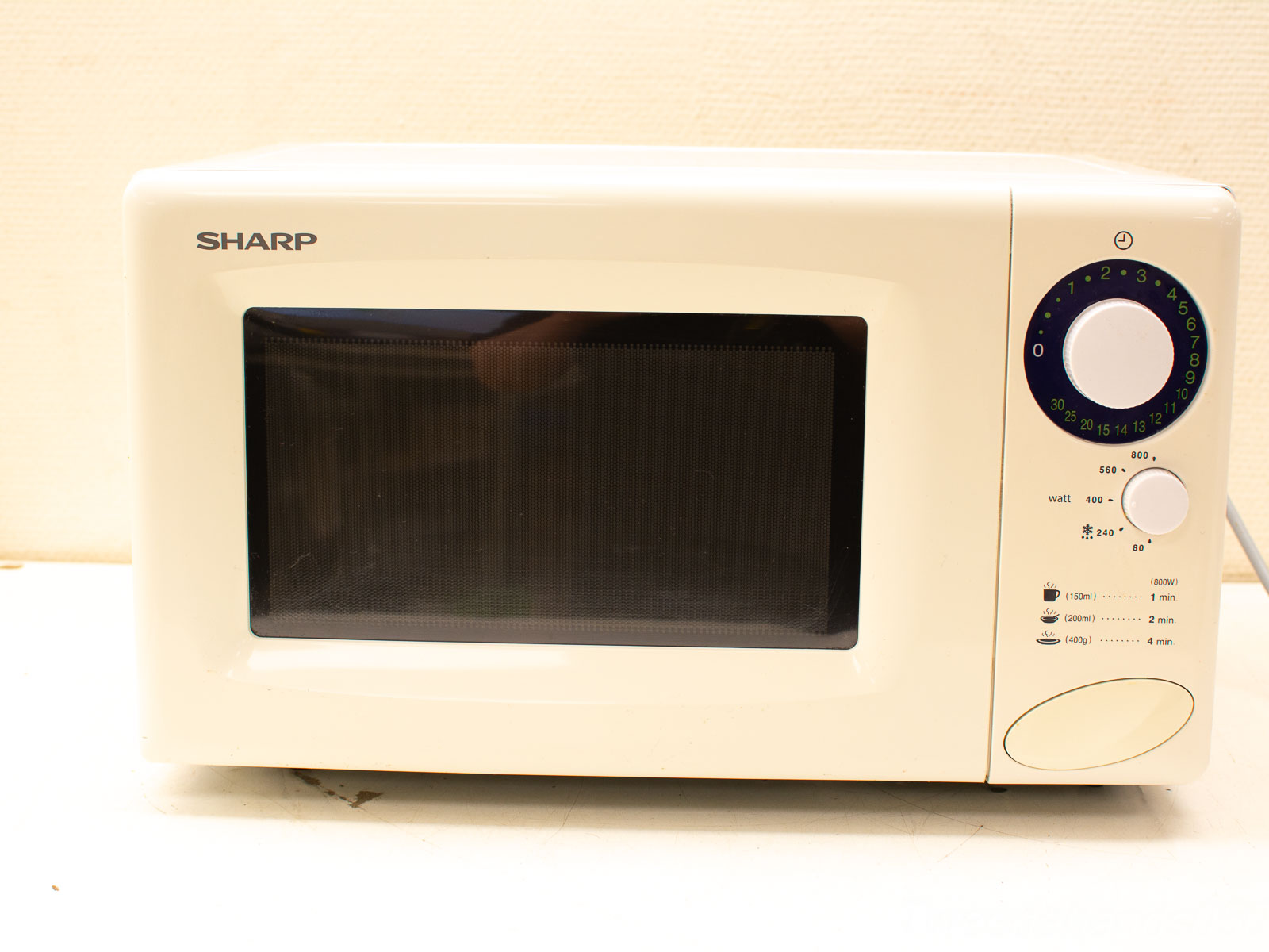 Sleek white Sharp microwave: compact design, user-friendly controls, perfect for modern kitchens.