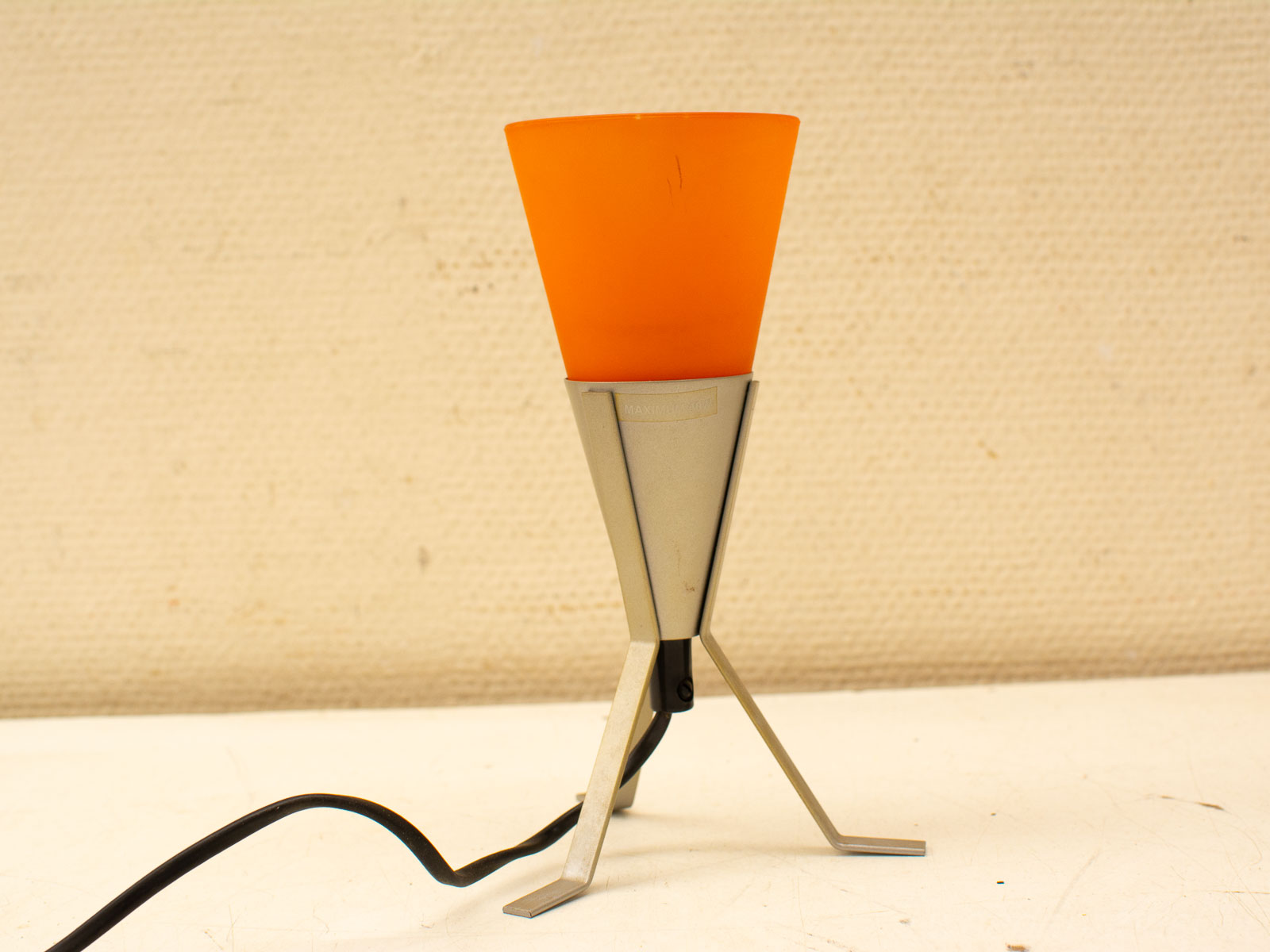 Modern orange table lamp with sleek metal base, perfect for stylish decor and cozy lighting.