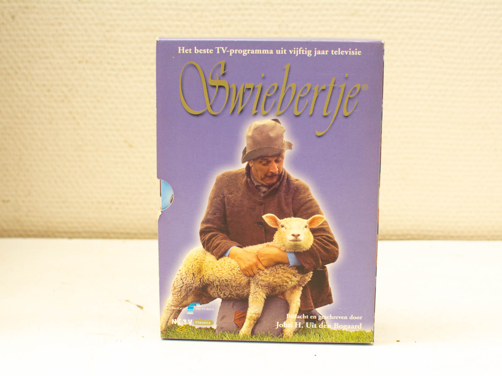 Swiebertje VHS cover: a nostalgic classic with a man and sheep on a purple backdrop.