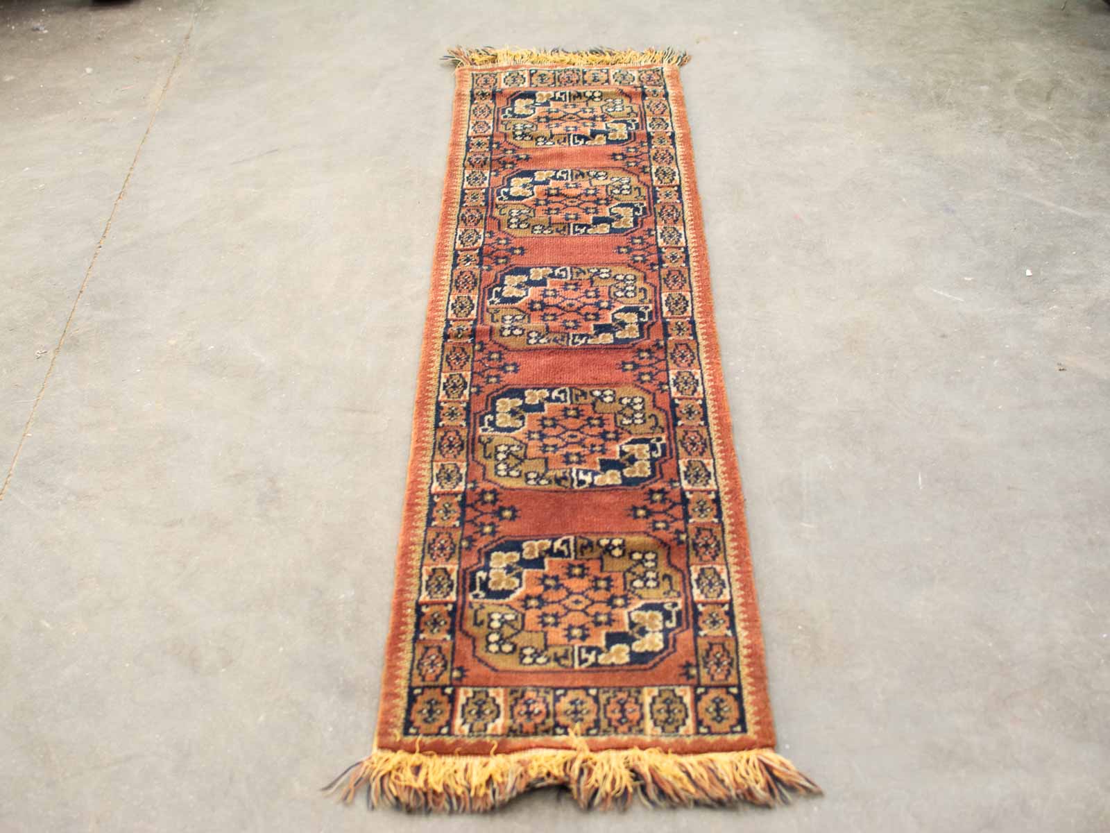 Elegant terracotta runner rug with intricate medallions and floral patterns, perfect for any decor.