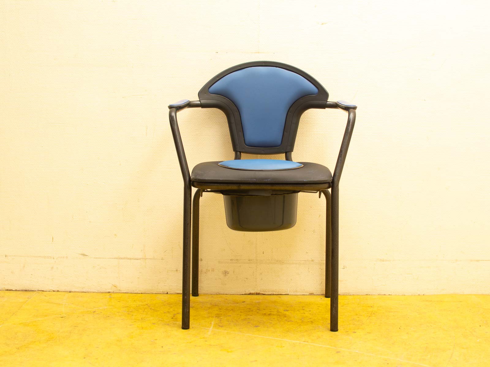 Modern blue chair with black metal frame and hidden storage for home or office use.