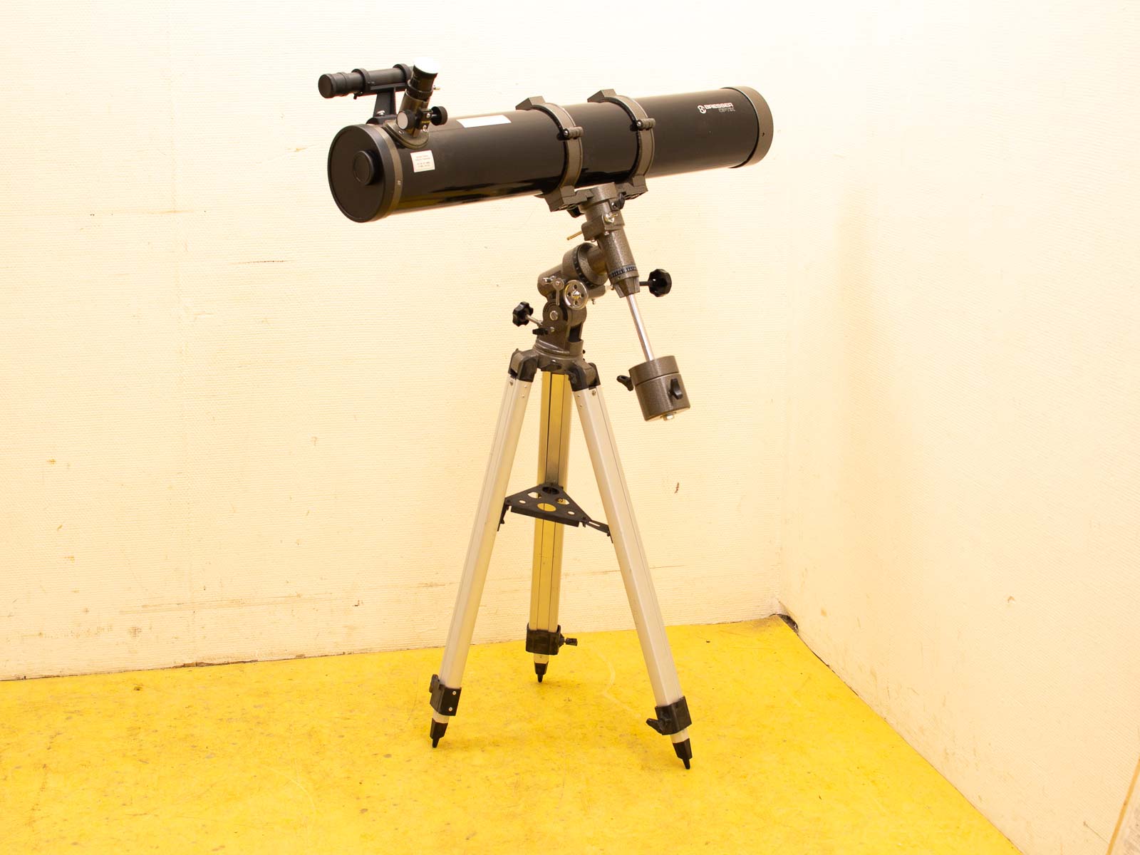 Sleek black telescope on sturdy tripod, ideal for stargazing and celestial observations.