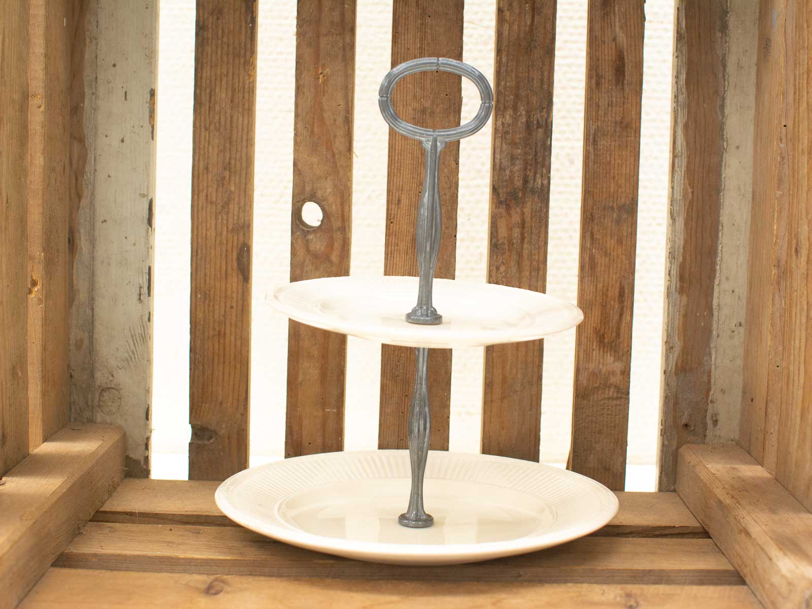 Elegant two-tiered serving stand with metallic handle, perfect for showcasing treats and pastries.