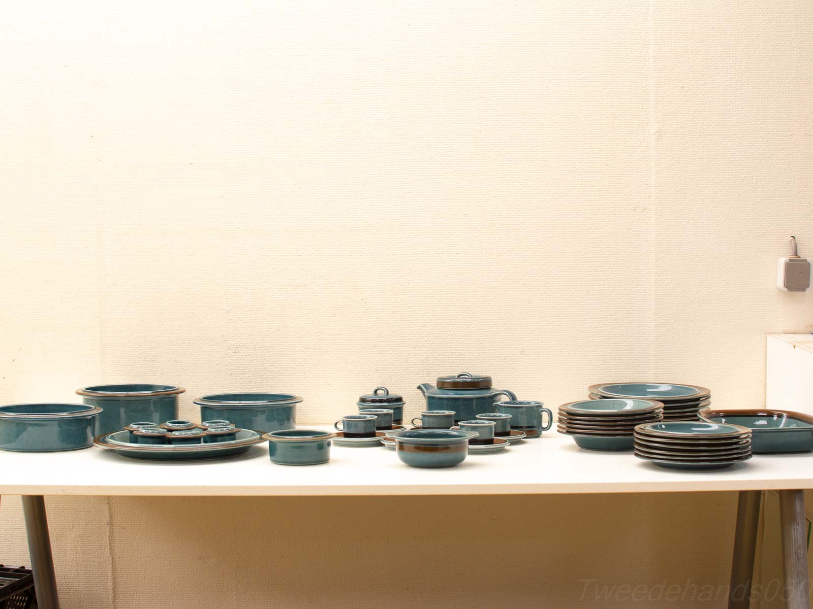 Elegant blue-green ceramic dishware set for cozy gatherings, featuring glossy plates, bowls, and cups.