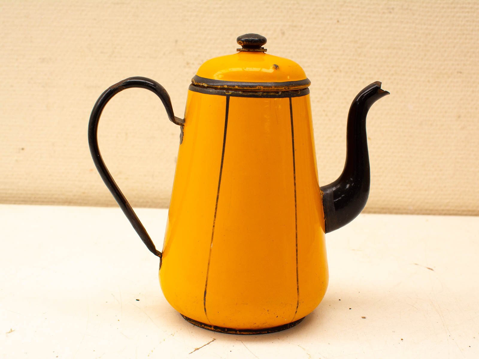 Vintage yellow coffee pot with black accents, perfect for collectors and coffee lovers.