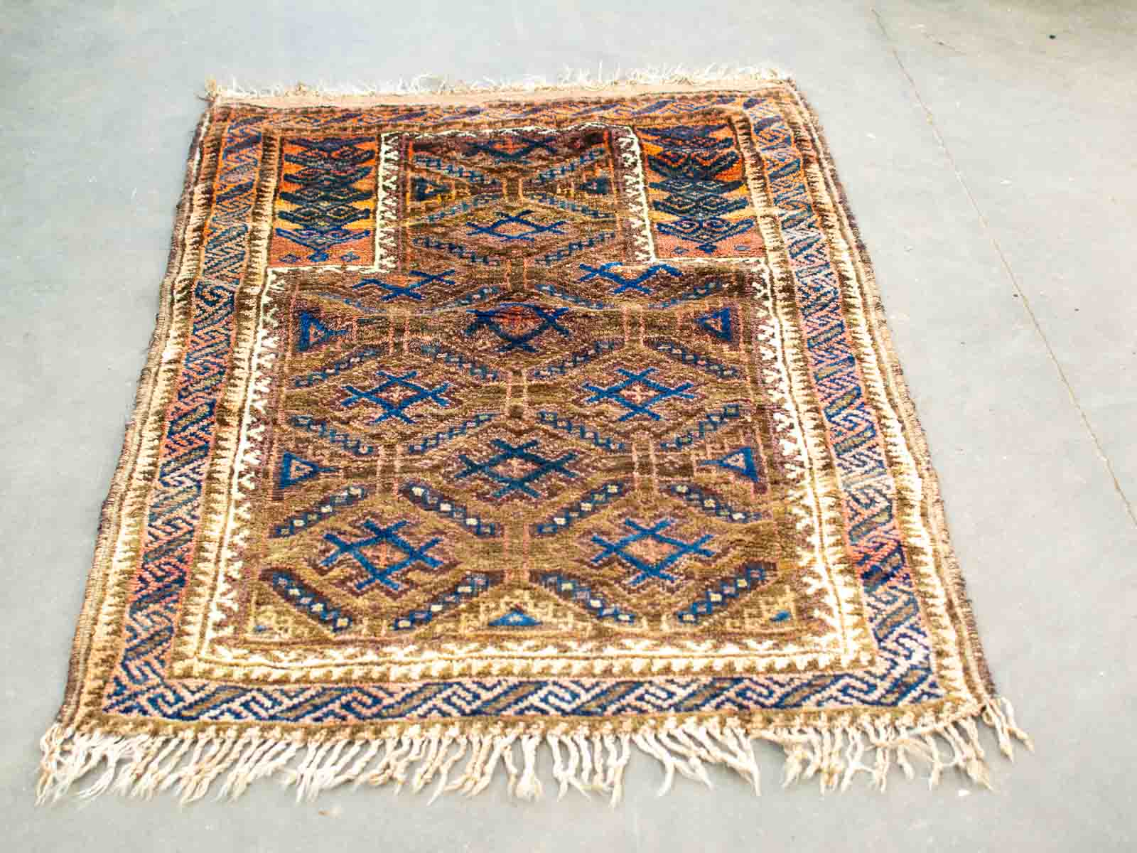 Vibrant handwoven vintage rug with intricate geometric patterns in rich colors, perfect for any decor.