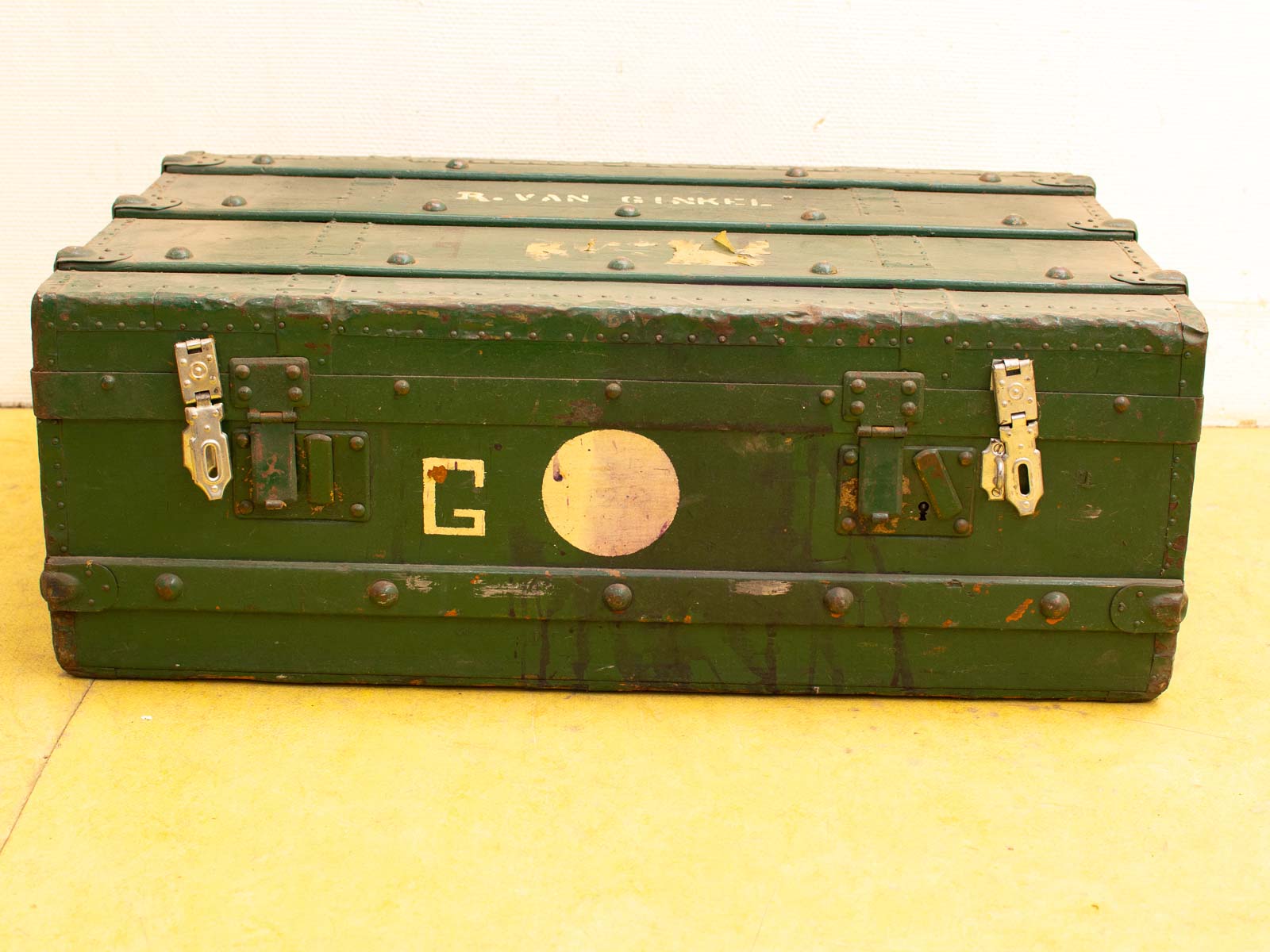 Vintage green trunk with personal touches, featuring the letter G and R. VAN. Perfect for collectors.