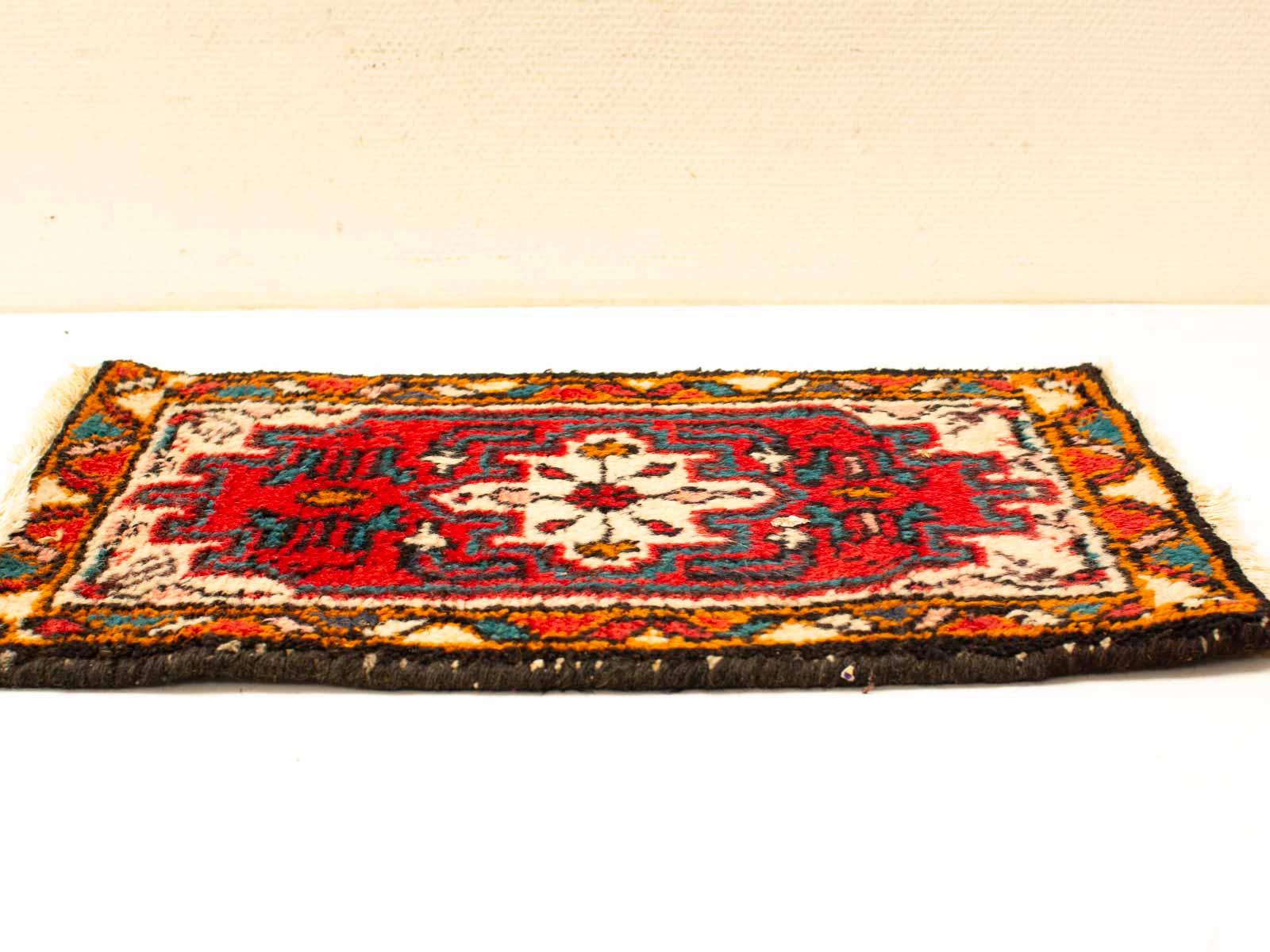 Vibrant handwoven rug with floral designs, showcasing traditional craftsmanship and rich cultural heritage.