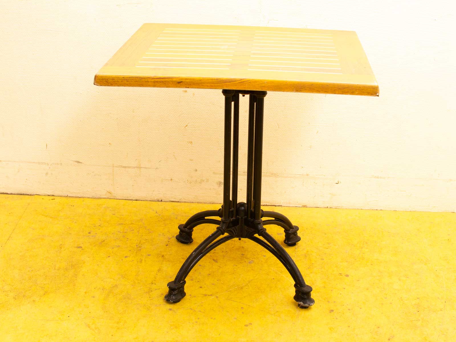 Elegant wooden table with metal base, perfect for casual gatherings in any setting.