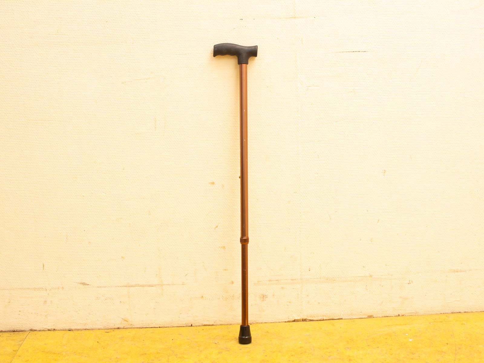 Ergonomic vintage cane with a warm brown finish, T-shaped handle, and rubber tip for stability.