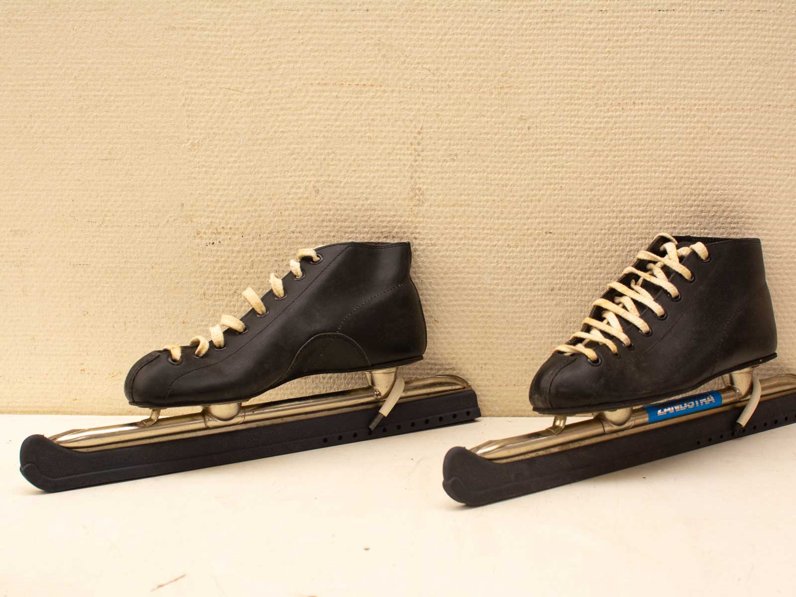 Classic black leather ice skates with shiny blades, embodying elegance and nostalgia for winter sports.