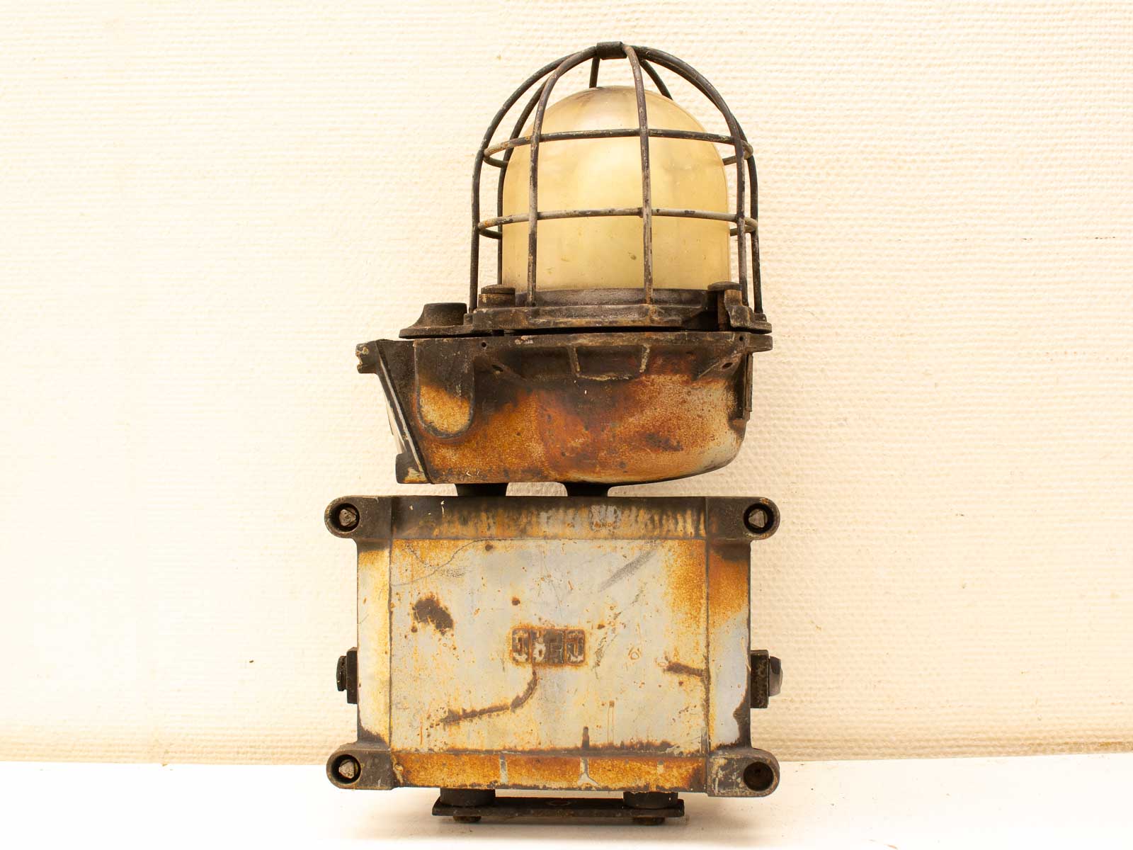 Rustic vintage industrial lamp with metal cage and yellow dome, perfect for nostalgic decor.