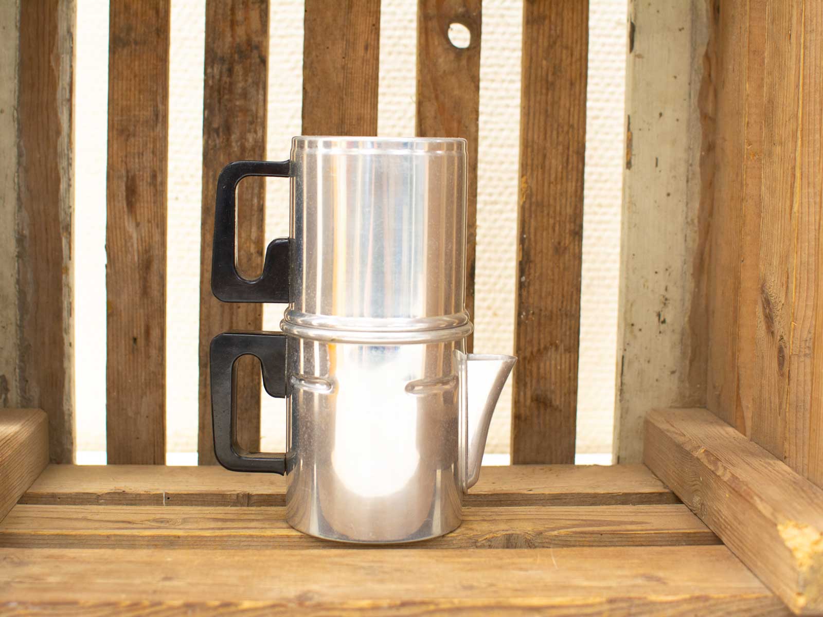 Elegant moka pot on rustic wooden backdrop, perfect for vintage coffee lovers and cozy gatherings.