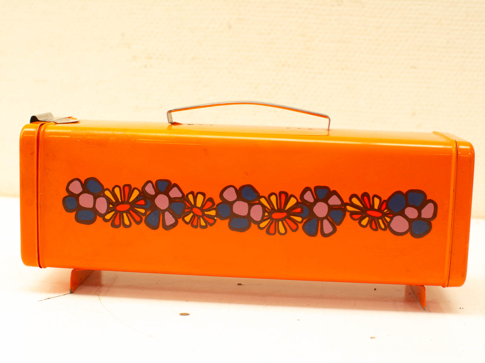 Cheerful Vintage Orange Metal Lunchbox with Retro Floral Design