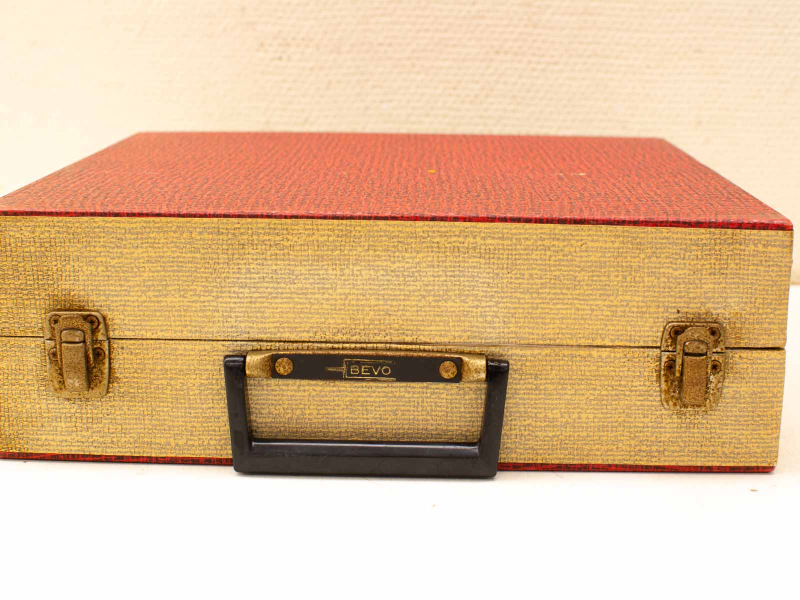 Vintage Bevo briefcase in striking red and gold, perfect for collectors and enthusiasts.