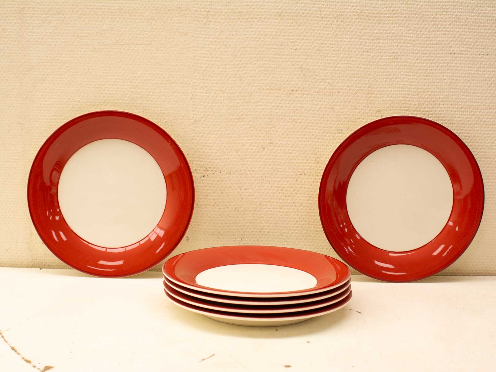 Vibrant red and white vintage plate set, perfect for stylish dining and collectible charm.