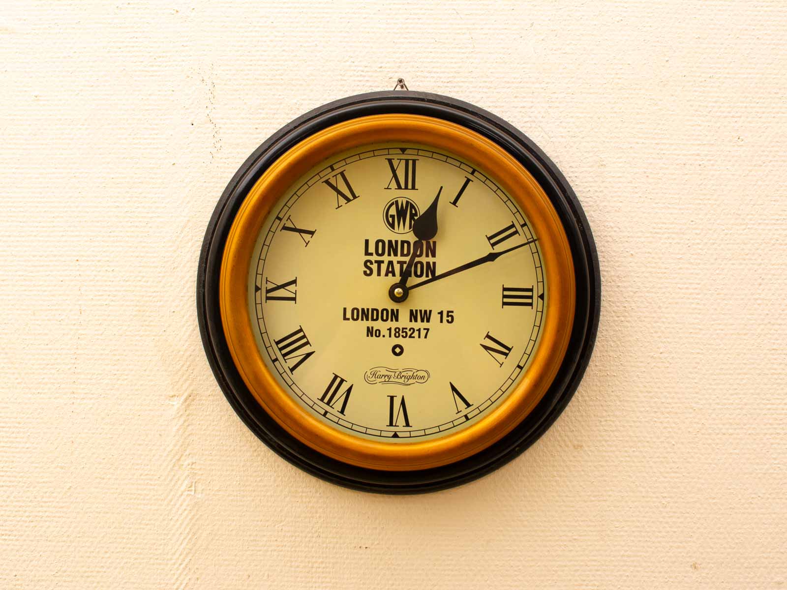 Elegant vintage wall clock in black and gold, inspired by Londons historical railway station.